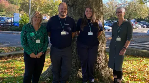 LDRS Four members of the Dog Warden service standing in front of a tree