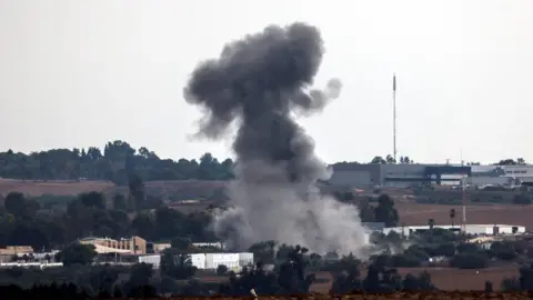 Reuters A rocket launched from the Gaza Strip strikes an area near Sderot, southern Israel, on 9 October.