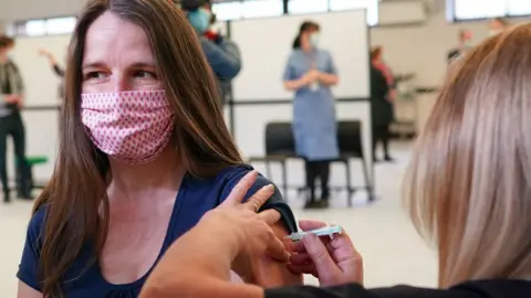 Getty Images Woman being vaccinated in Penrith, England, in March