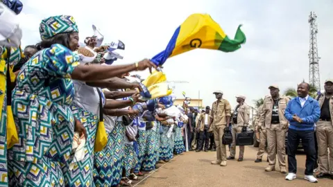 Getty Images Ali Bongo Ondimba (right, with blue jacket) at his campaign rally in Ntoum, Gabon, 20 August 2023