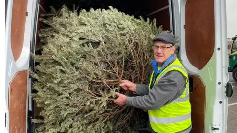 East Cheshire Hospice  Volunteer with tree