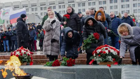 Reuters Participants lay flowers near the Eternal Flame memorial in Samara, Russia, January 3, 2023