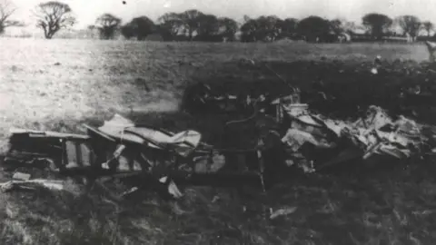 Chris Davies  A black and white image of the wreckage of two planes