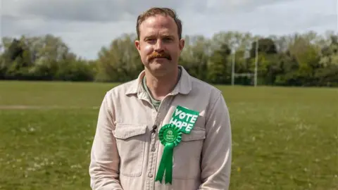 The Green Party's Rob Yates stood in a field. 