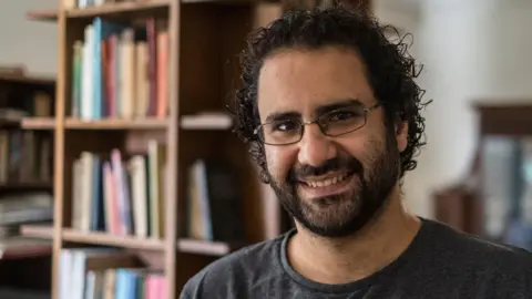 AFP Alaa Abdel Fattah smiles during an interview at his home in Cairo on 17 May 2019 (file photo)