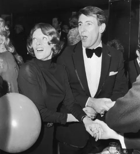 Getty Images Smith and Stephens lead the singing of 'Auld Lang Syne' at a New Year's Eve party in 1973.