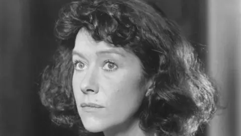 Silver Screen Collection A black and white photo of a woman with short dark hair.
