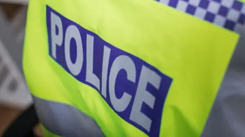 a close up of a fluorescent yellow police vest