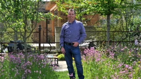 Encore PR Mark Draper stood in his garden