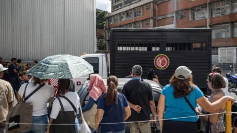 EPA Relatives of those detained during the protests wait in line to enter the headquarters of the Bolivarian National Police in Caracas