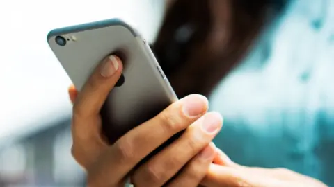 Getty Images A person holding a smartphone