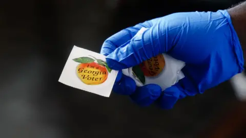 Getty Images Voters are handed a sticker saying they voted