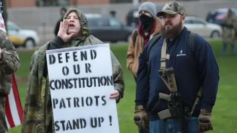 Getty Images Demonstrators hold a rally in front of the Michigan state capital building to protest the governor's stay-at-home order on May 14, 2020 in Lansing, Michigan. Governor Gretchen Whitmer imposed the order to curtail the spread of the coronavirus COVID-19