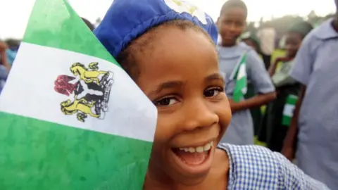 AFP A Nigerian student smiles as she attends independence day celebrations in Lagos ion 1 October 2013