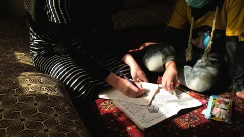 Reuters Girl writes in a notebook
