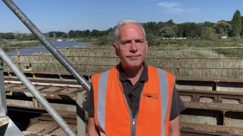 Richard Cooper/Network Rail Man standing near bridge