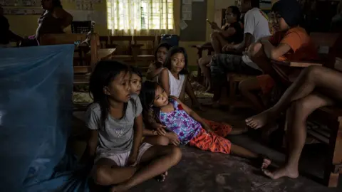 Getty Images Children sitting on the floor of a classroom in Tuguegarao