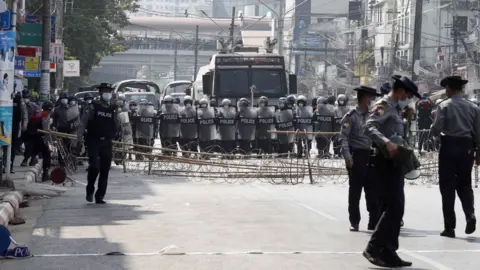 EPA Riot police block a road in Yangon
