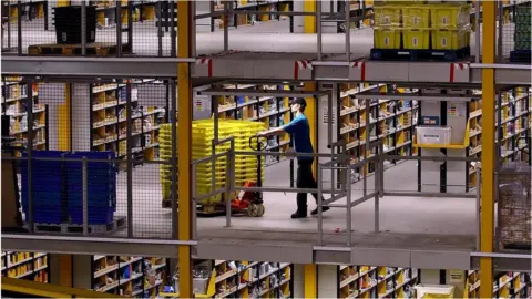 Getty Images A worker at Amazon's Swansea warehouse