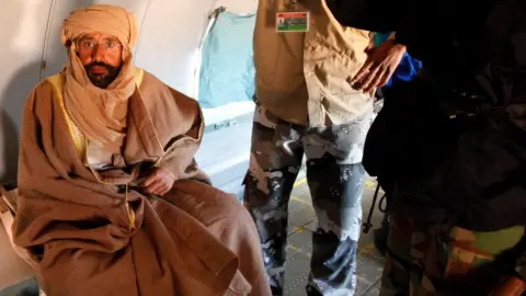 Reuters Saif al-Islam Gaddafi is seen sitting in a plane in Zintan November 19, 2011