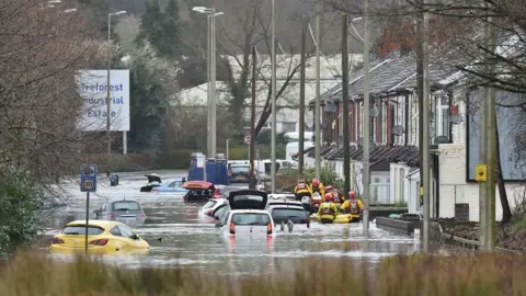 PA Wire A flooded road in Nantgarw, Wales