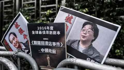 Getty Images Placards showing missing bookseller Lee Bo (L) and his associate Gui Minhai (R)