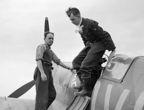 IWM CH 1355 Flight Sergeant George 'Grumpy' Unwin of No. 19 Squadron climbs out of his Spitfire at Fowlmere after a sortie, September 1940