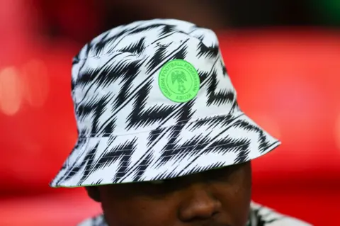 Getty Images A fan wearing a Nigeria hat during the International Friendly match between England and Nigeria at Wembley Stadium on June 2, 2018 in London, England.