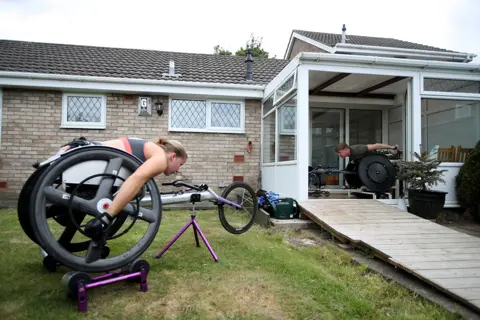 Molly Darlington/ Reuters Two wheelchair athletes train outside their homes