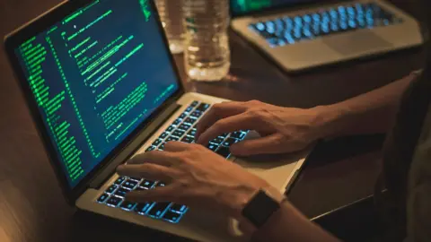 Getty Images Stock image of a hacker using a computer