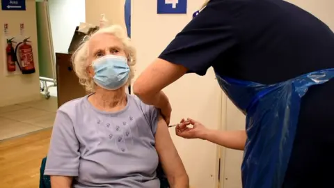 University Hospitals Birmingham Mrs Lihou getting jab