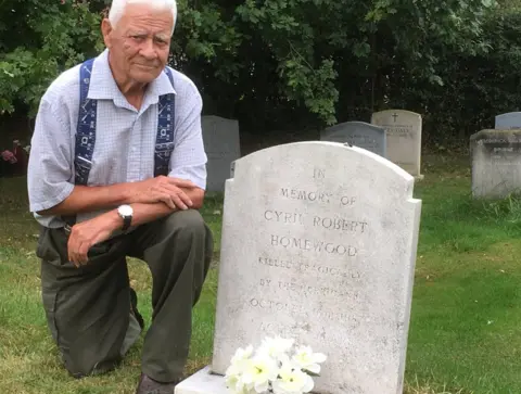 Alec Homewood next to his brother's grave