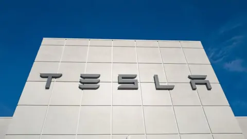 Getty Images Tesla logo on a dealership