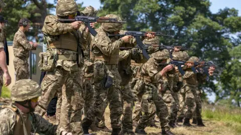 PA Media New recruits to the Ukranian army being trained by UK armed forces personnel at a military base near Manchester