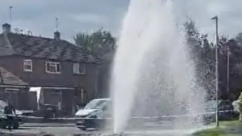 Water pours from a burst main on Liverpool Road, Worcester
