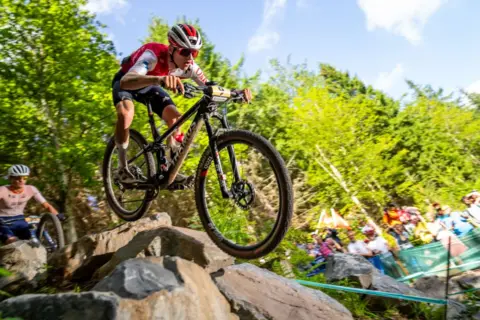 EPA Luke Wiedmann from Switzerland in action during the Men's Under 23 Cross-Country Olympic final at the UCI Cycling World Championships 2023 in Glentress,