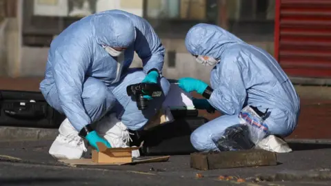 PA Media Forensic officers work near Forbury Gardens, in Reading town centre