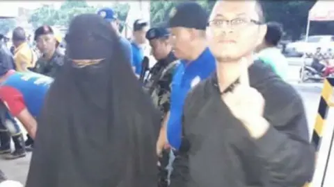 Northern Mindanao Police Eyadzhemar Abdusalam and wife after being arrested last year