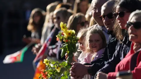 Jacob King/PA Wire Members of the public awaiting the arrival of King Charles III and the Queen Consort at Llandaff Cathedral in Cardiff, for a Service of Prayer and Reflection for the life of Queen Elizabeth II