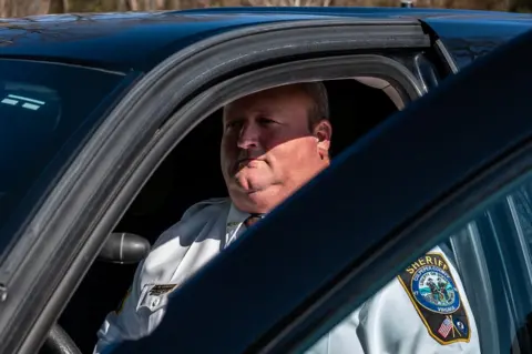 Joel Gunter Sheriff Scott Jenkins in his patrol car. He has offered to deputise thousands of citizens