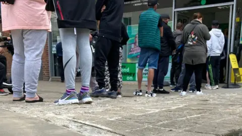 People queuing outside the Cash Shop