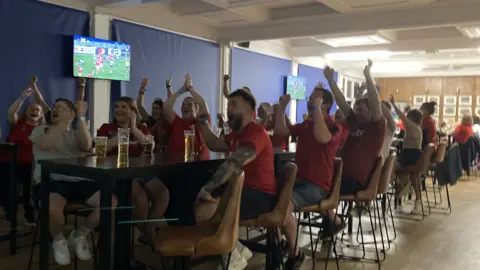 Fans celebrate Wales' first try at Cardiff Arms Park