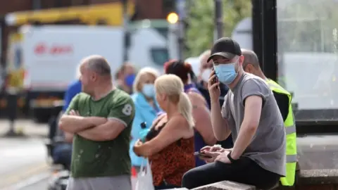 Reuters People wait in line at a testing centre