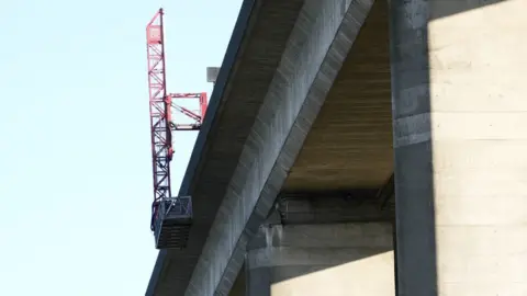 John Fairhall/BBC Hydraulic arm over the Orwell Bridge