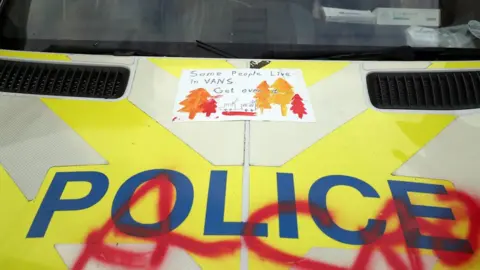 PA Media Graffiti on police van