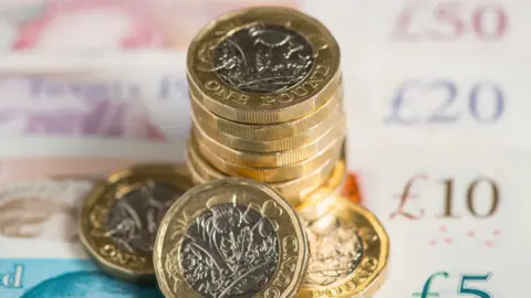 Dominic Lipinski/PA Wire British sterling pound coins and bank notes
