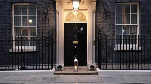 No 10/Twitter Prime Minister Boris Johnson's official Twitter account shared a photo of a candle lit outside the front door of No 10 Downing Street