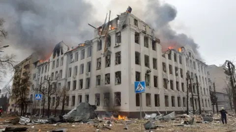 Getty Images Firefighters work to contain a fire at Karazin Kharkiv National University, hit during recent shelling