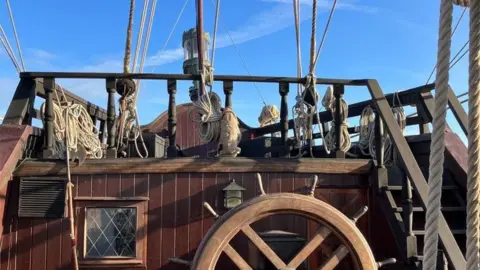 A view of the ship's deck and helm