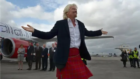 Getty Images Sir Richard Branson arrives in Edinburgh Airport on April 8, 2013 in Edinburgh, Scotland. He arrived aboard the inaugural Virgin Atlantic Little Red flight.